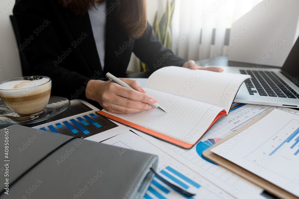 business woman working project, planning strategy, taking notes in modern office. University student