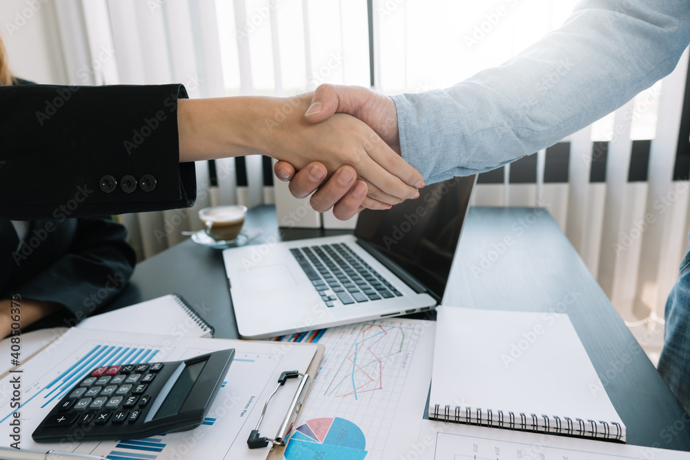 Business people shaking hands, finishing up meeting.