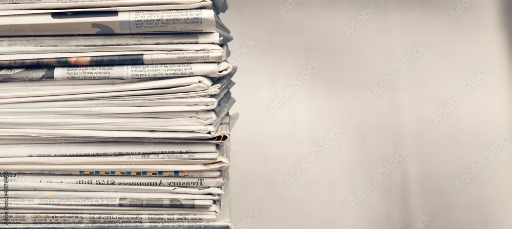 Pile of newspapers stacks on blur background