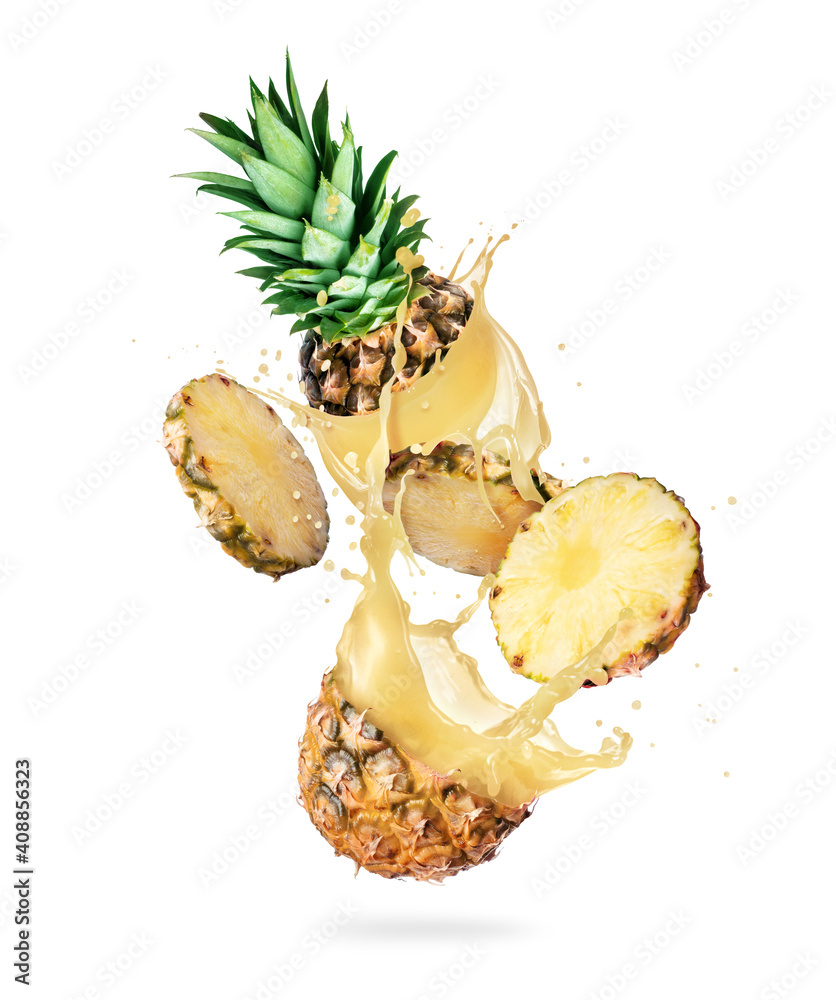 Chopped ripe pineapple with splashes of juice in the air on white background