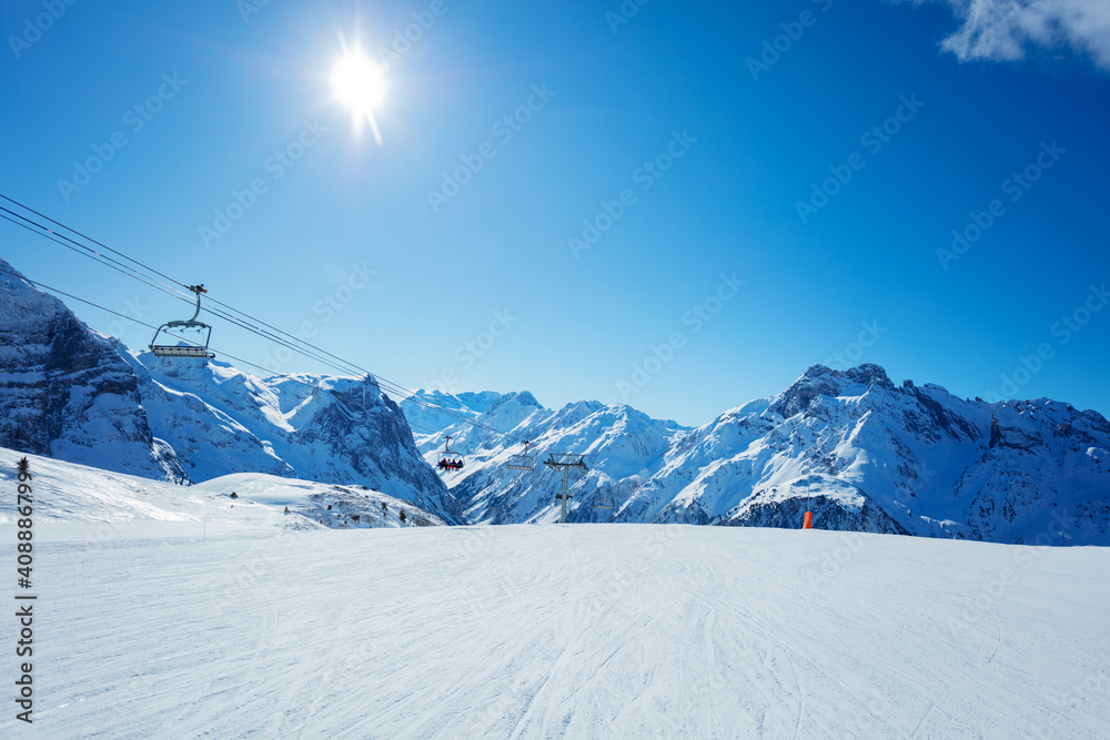 Alps mountain peaks and clean empty ski trails in Pralognan-la-Vanoise range over snowy tops