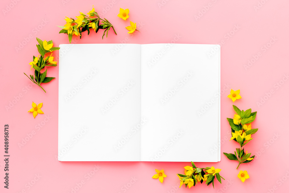 Blank greeting card with yellow flowers, top view. Floral background