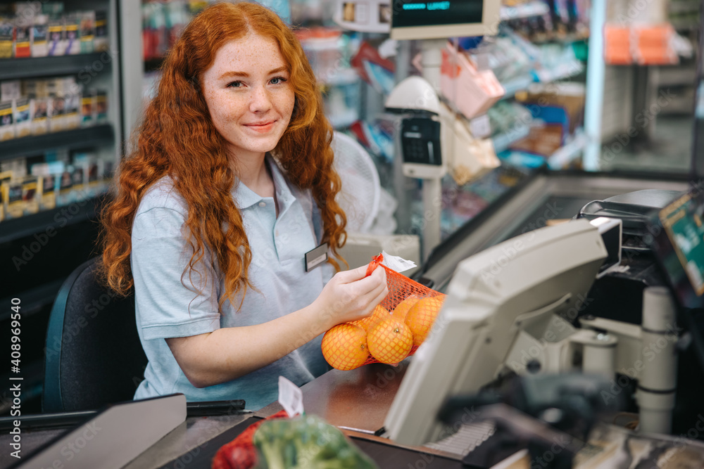 Cashier on checkout in supermarket