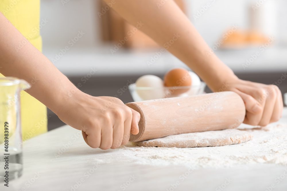 Woman making dough in kitchen