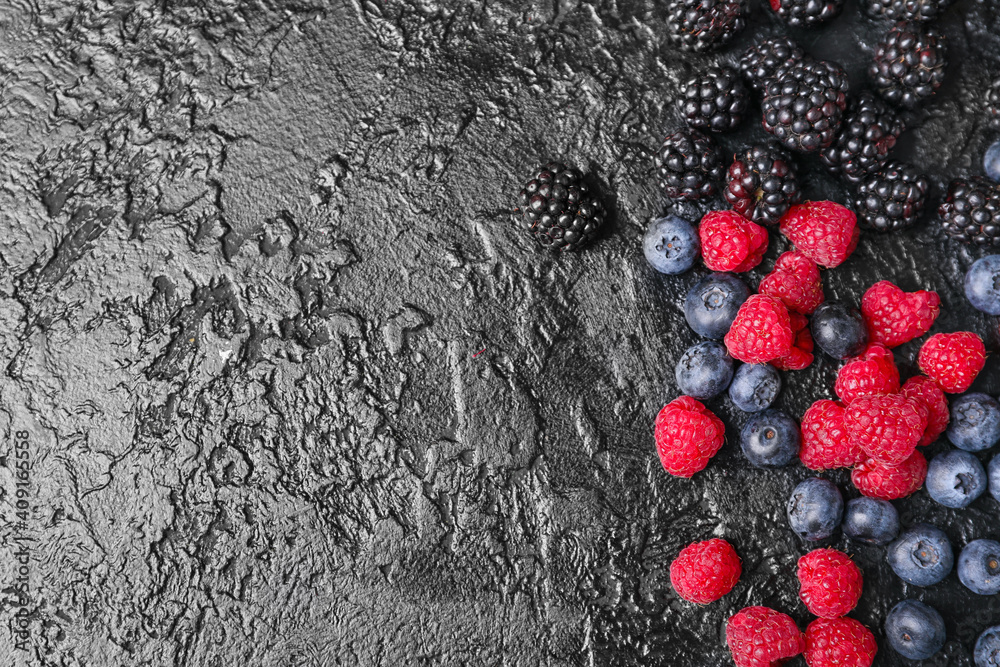 Different tasty berries on dark background