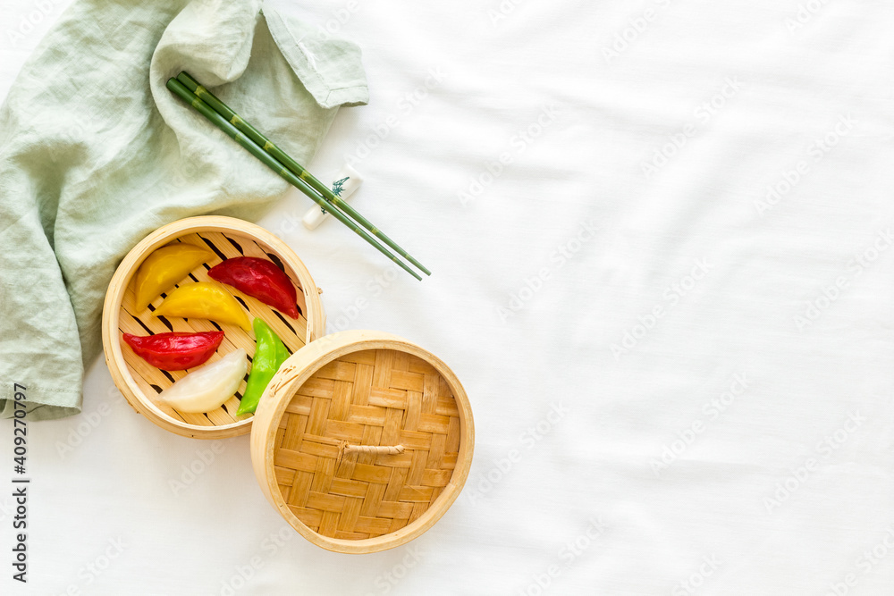 Colored vegetables dumplings totellini in wooden steamer. Traditional Asian food