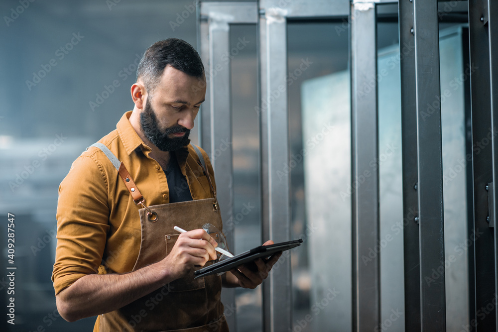 Worker with a digital tablet at the plant