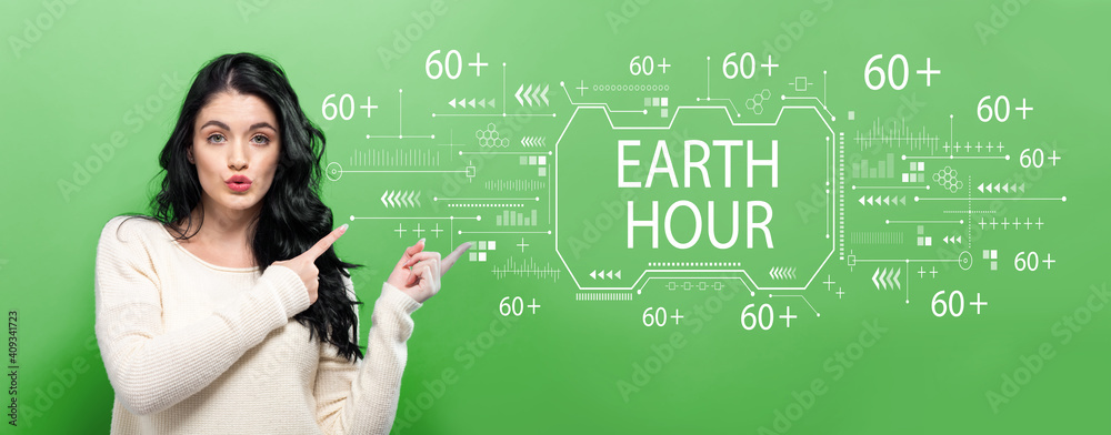 Earth hour with young woman pointing on a green background