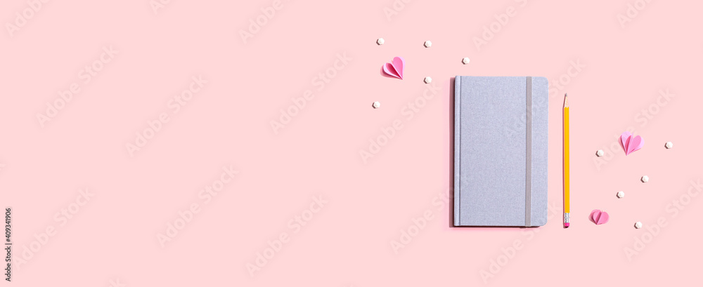 Gray notebook with paper hearts - flat lay