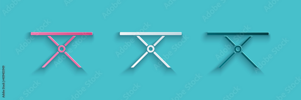 Paper cut Ironing board icon isolated on blue background. Steam iron. Paper art style. Vector.