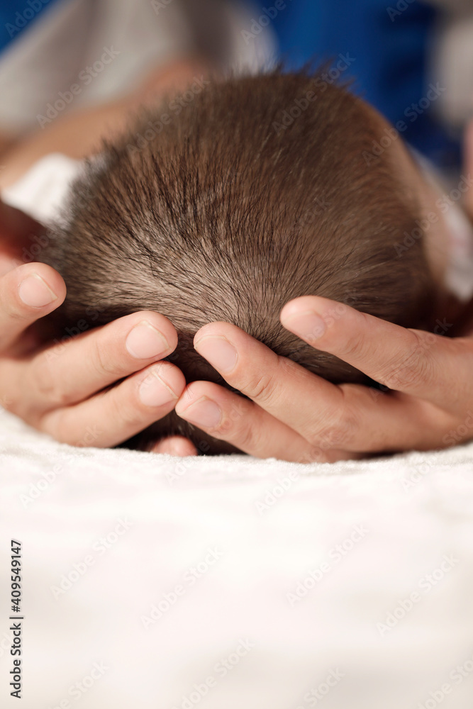 Father holding the head of baby