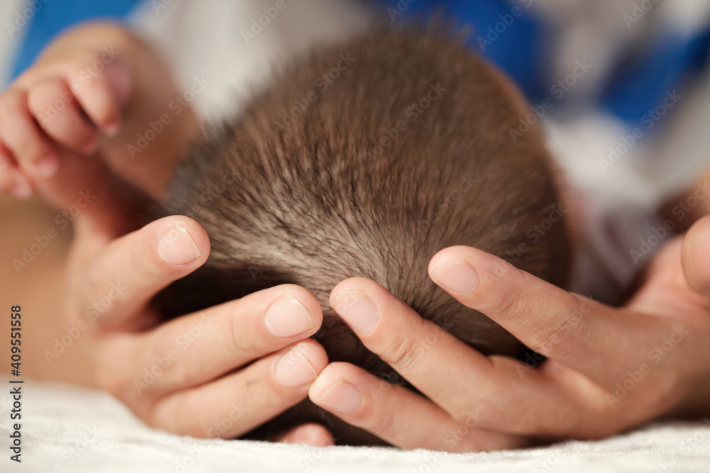 Father holding the head of baby