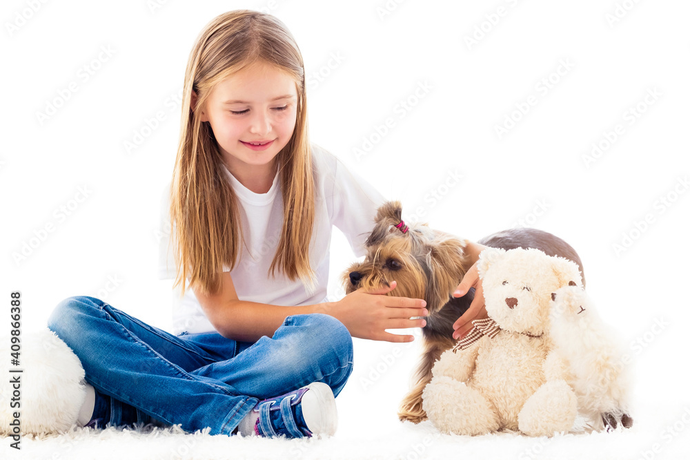 Little girl catching small dog in light room isolated on white