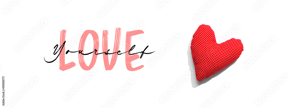 Love Yourself message with a red heart cushion - flat lay