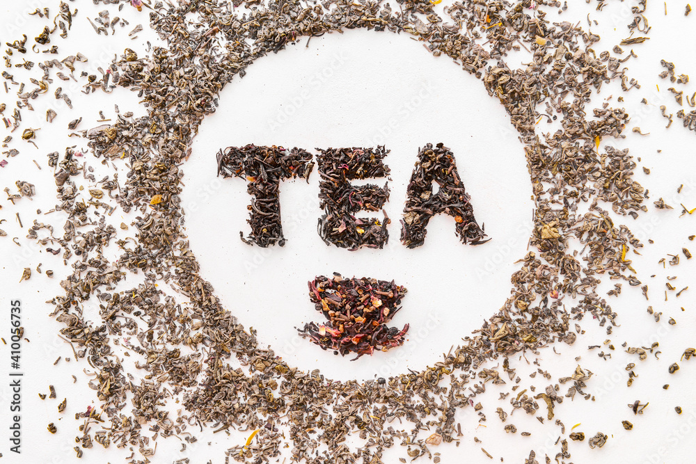 Word TEA made of dry leaves on white background