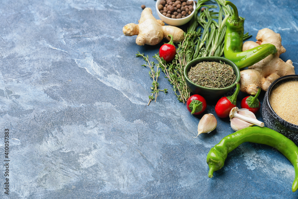 Composition with different spices and herbs on color background