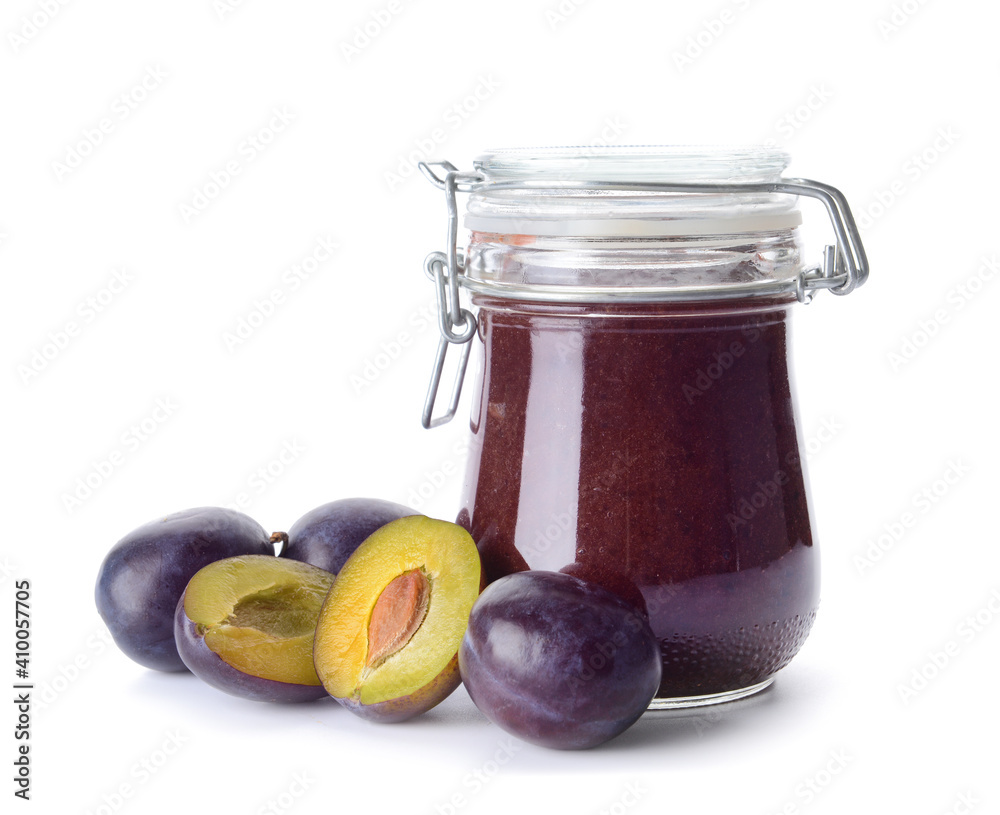 Glass jar with delicious homemade plum jam on white background