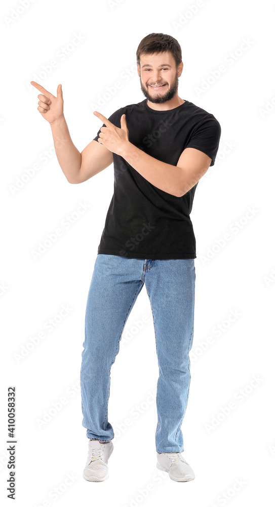 Portrait of young man showing something on white background