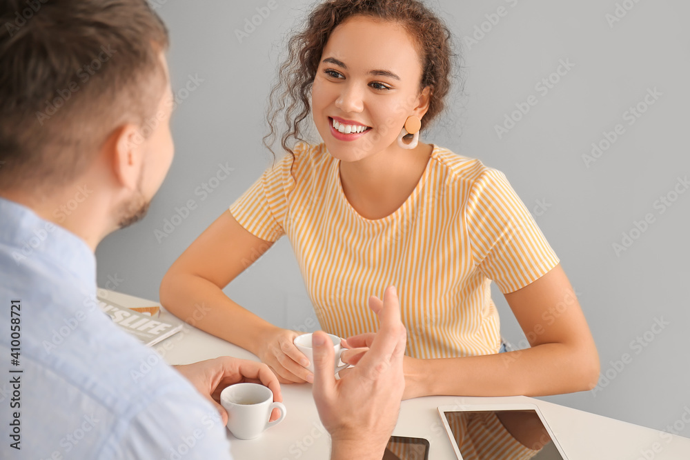 Happy couple drinking hot espresso on romantic date in cafe