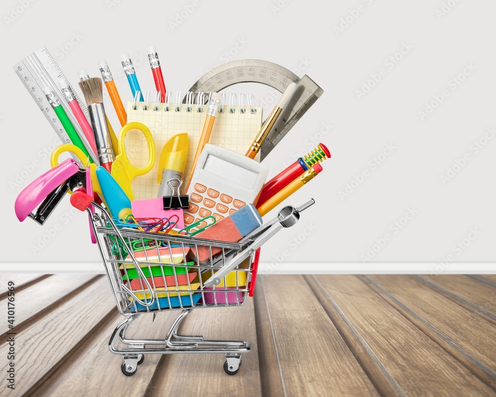 Stationery objects in mini supermarket cart on desk