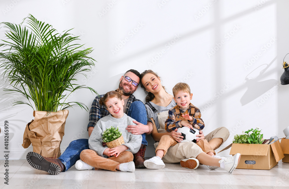 Cheerful family sitting of floor in new apartment