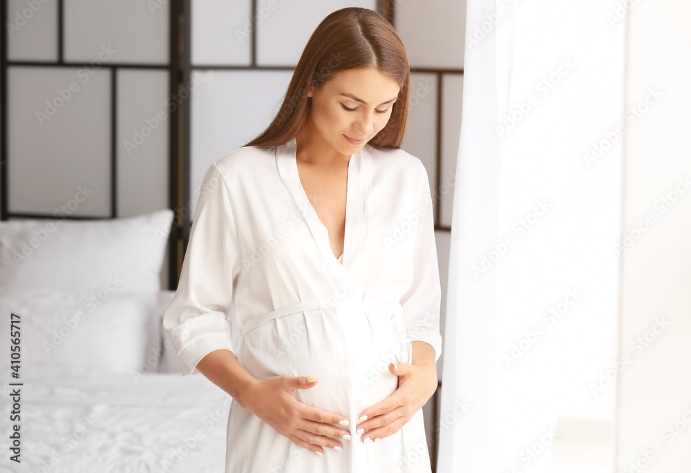 Beautiful pregnant woman at home