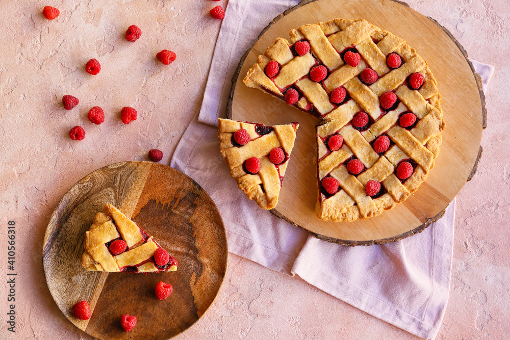 Delicious raspberry pie on color background