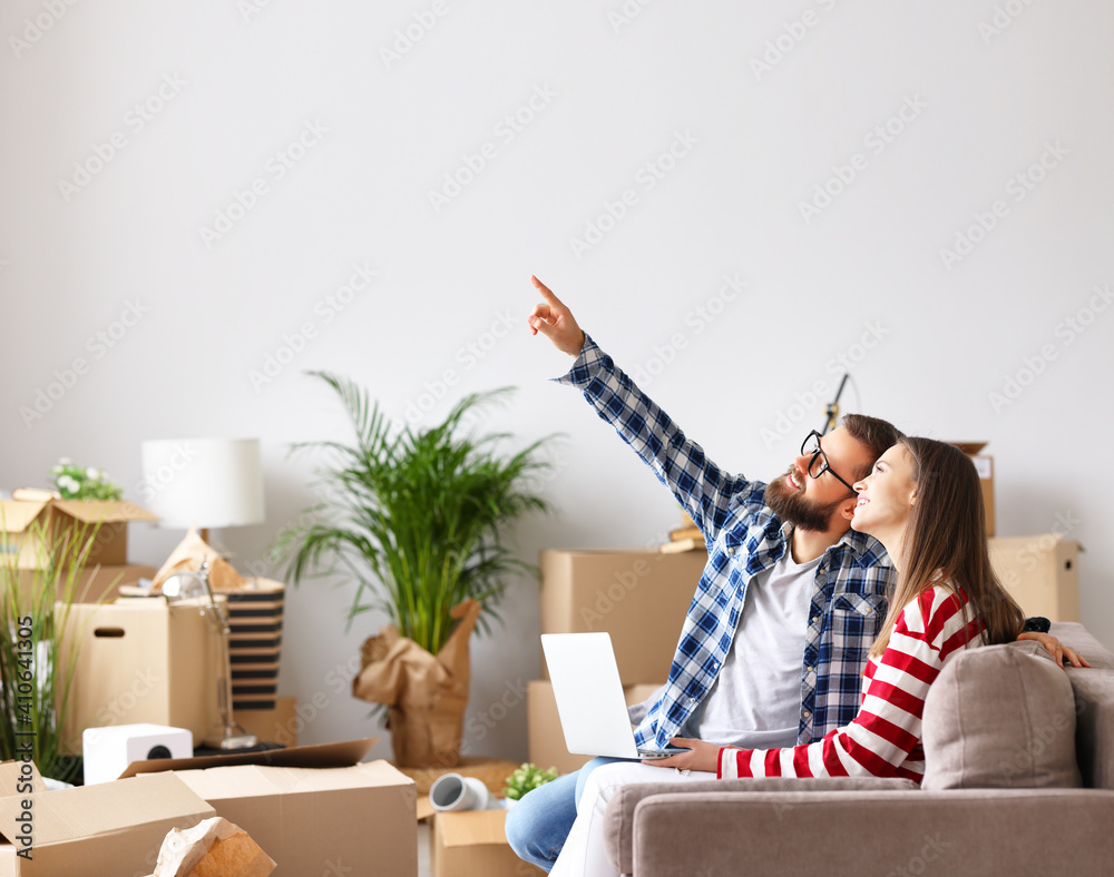 Positive couple with laptop discussing design of new home