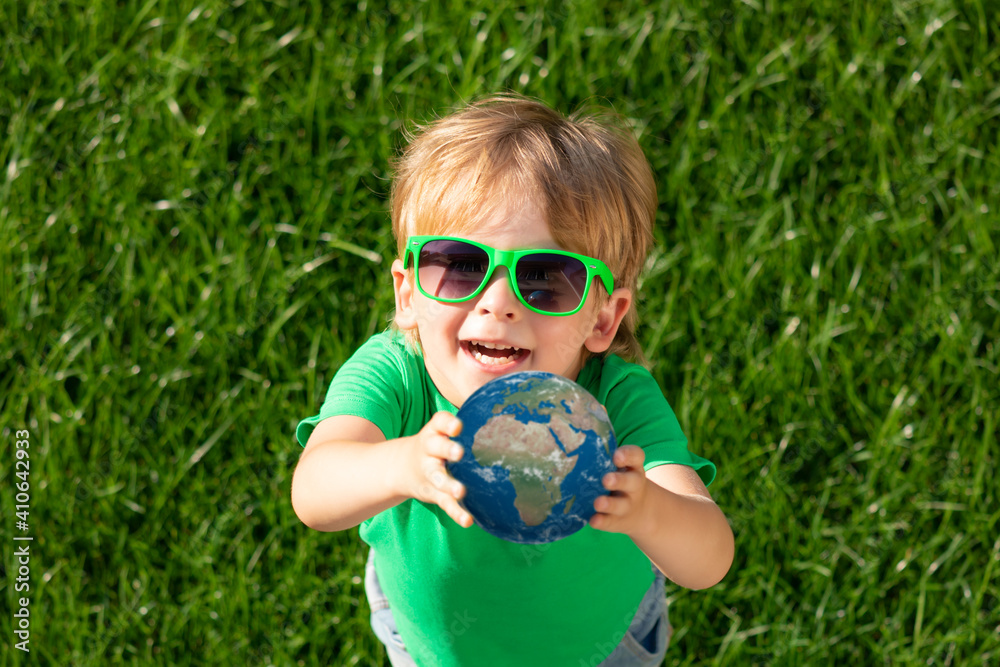 Child holding Earth planet in hands