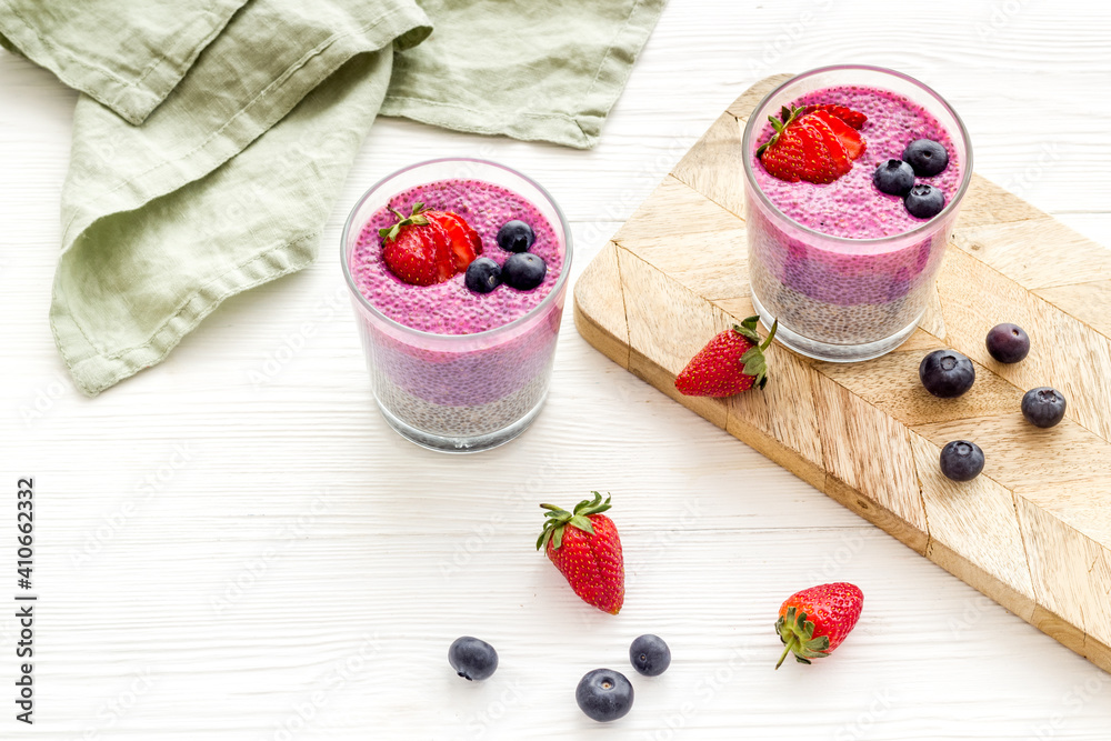 Chia seeds pudding dessert with yogurt and strawberries in glasses