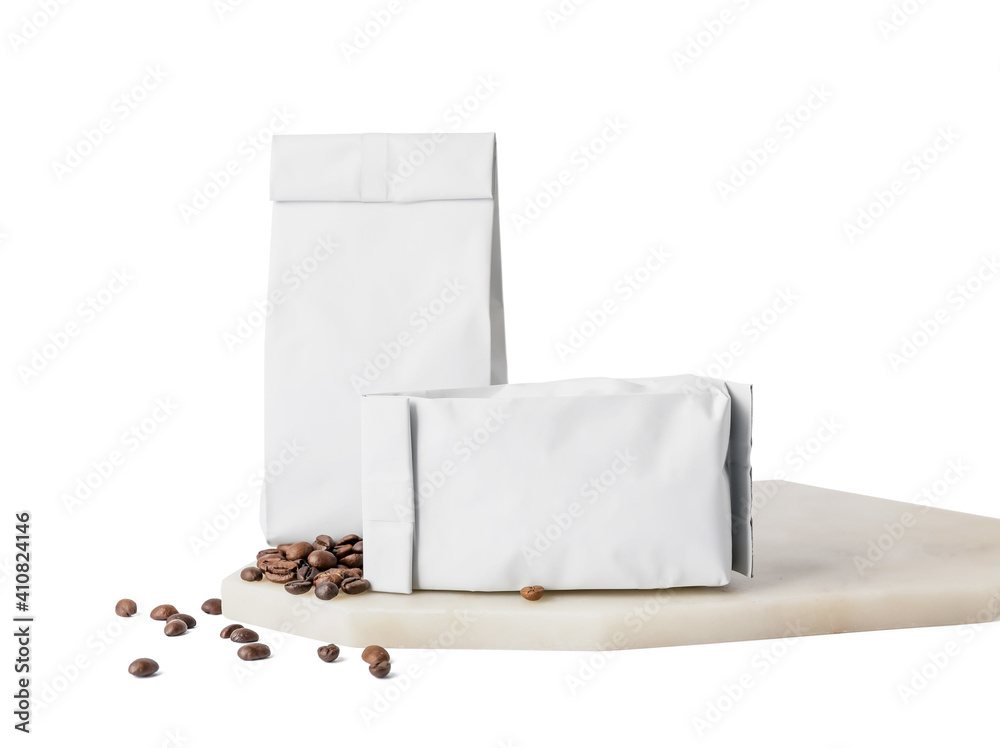 Board with coffee bags on white background