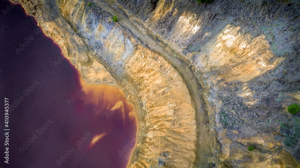 Red lake in Mitsero, Cyprus aerial view detail. Its unnatural red and yellow colors are the result o