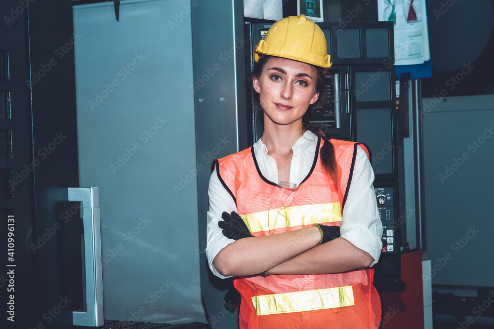 Young woman factory worker close up portrait in manufacturing job factory . Industry and engineering