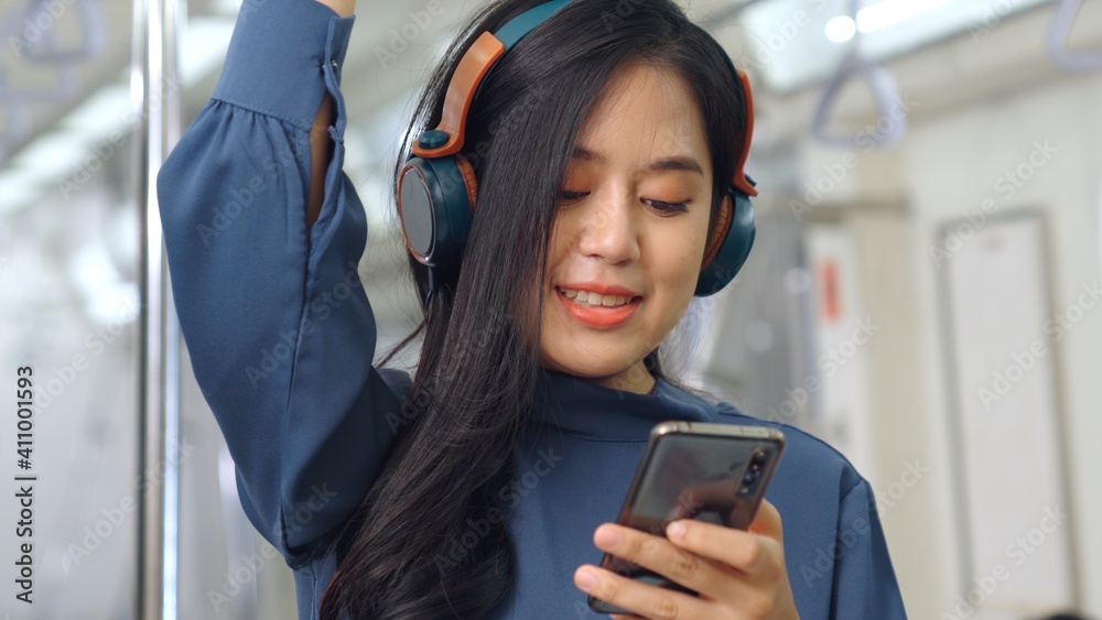 Young woman mobile phone on public train . Urban city lifestyle commuting concept .