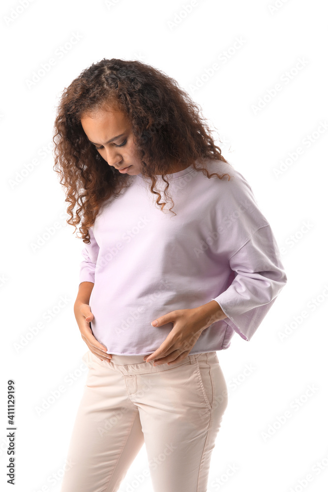 Stressed pregnant African-American woman on white background