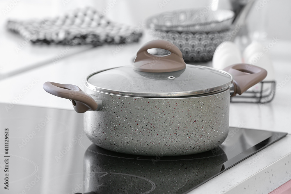 Cooking pot on electric stove in kitchen