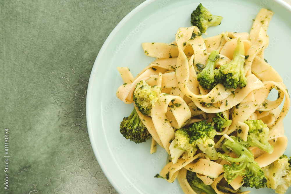 Delicious pasta with broccoli on color background, closeup