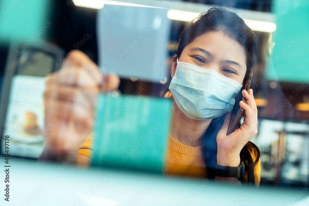 attractive freelance asian female creative person wear casual yellow cloth and face mask protection 