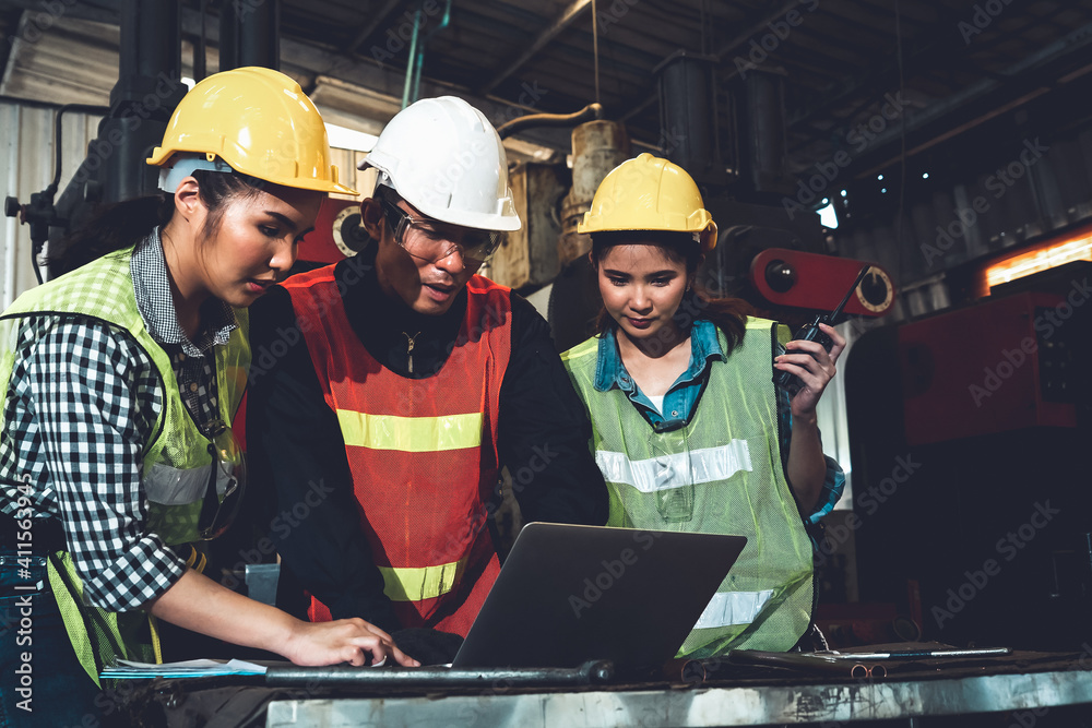 Factory job workers working and discussing manufacturing plan in the factory . Industry and engineer