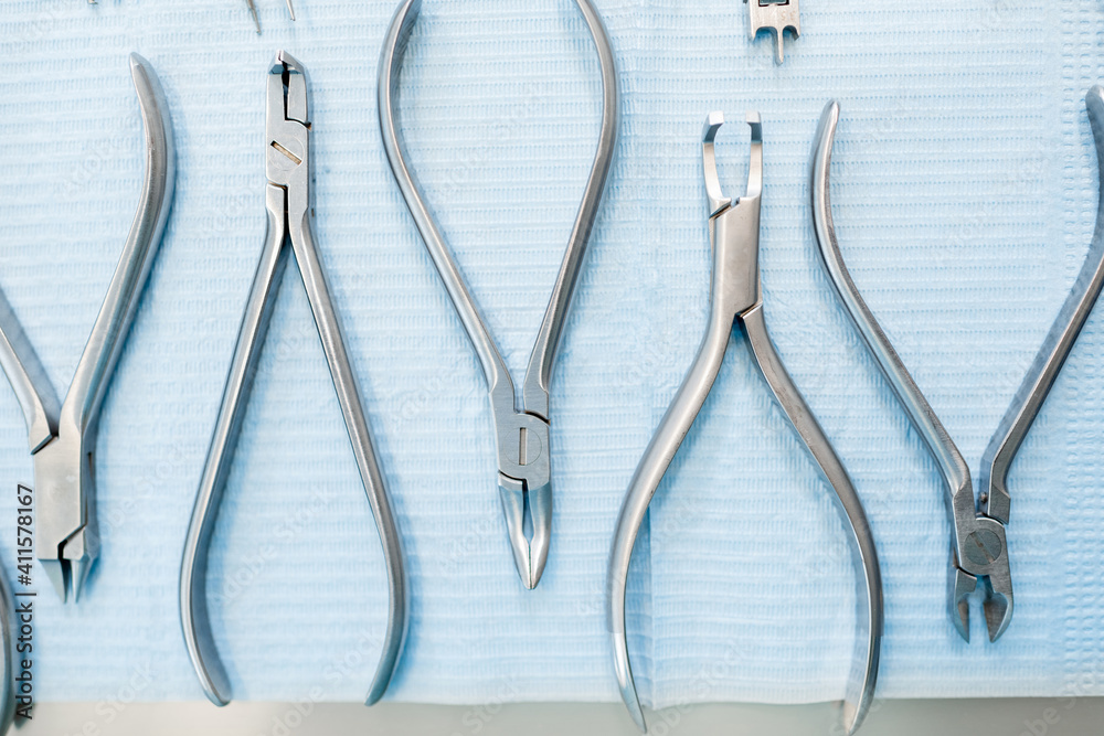 Dental tools for the orthodontic treatment lying on the table at the dental office, close-up. High q