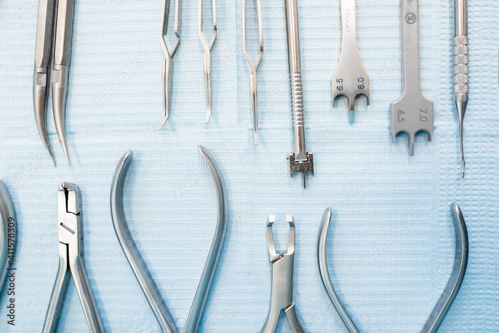 Dental tools for the orthodontic treatment lying on the table at the dental office, close-up. High q