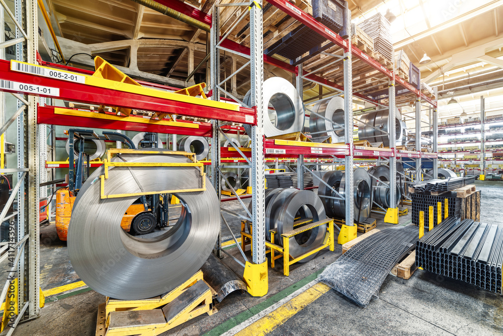 Factory stock wire. Wire spools lie on multi-tiered racks.