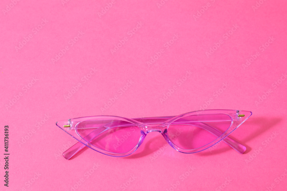 Stylish sunglasses on color background