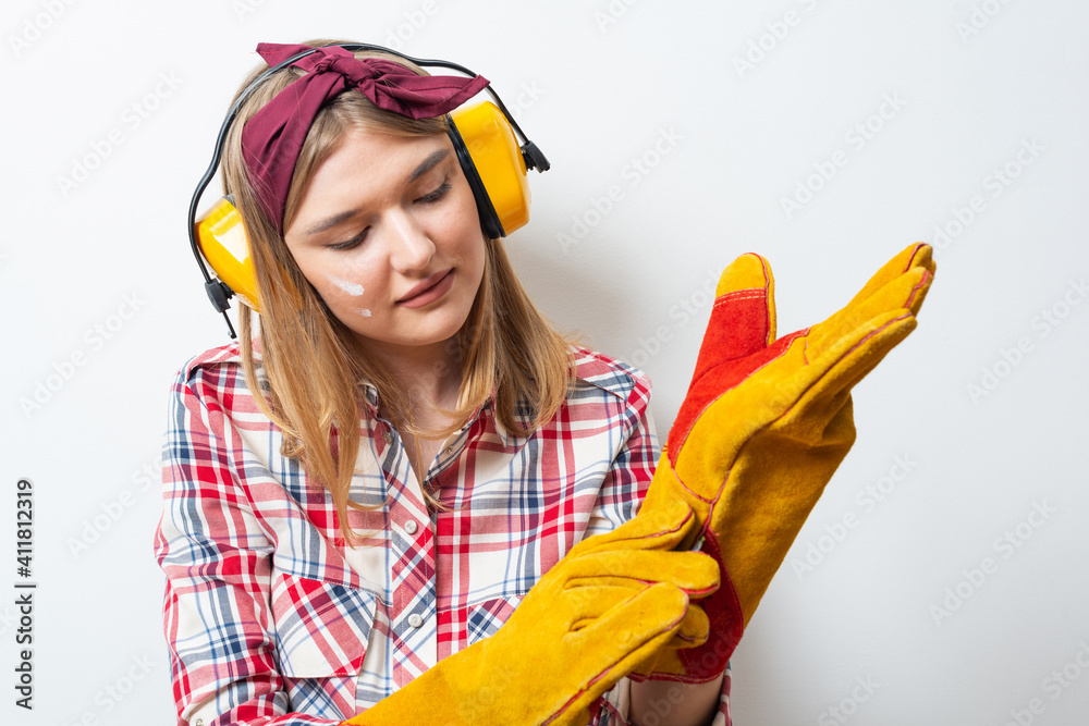 Attractive girl in protective headphones sitting