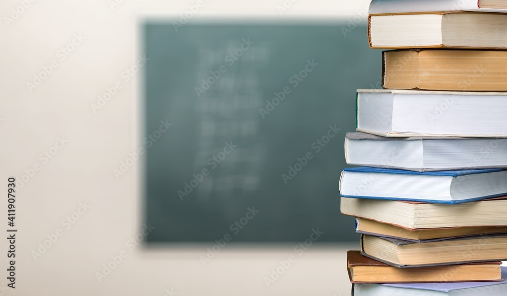 Collection of old books stack on school background