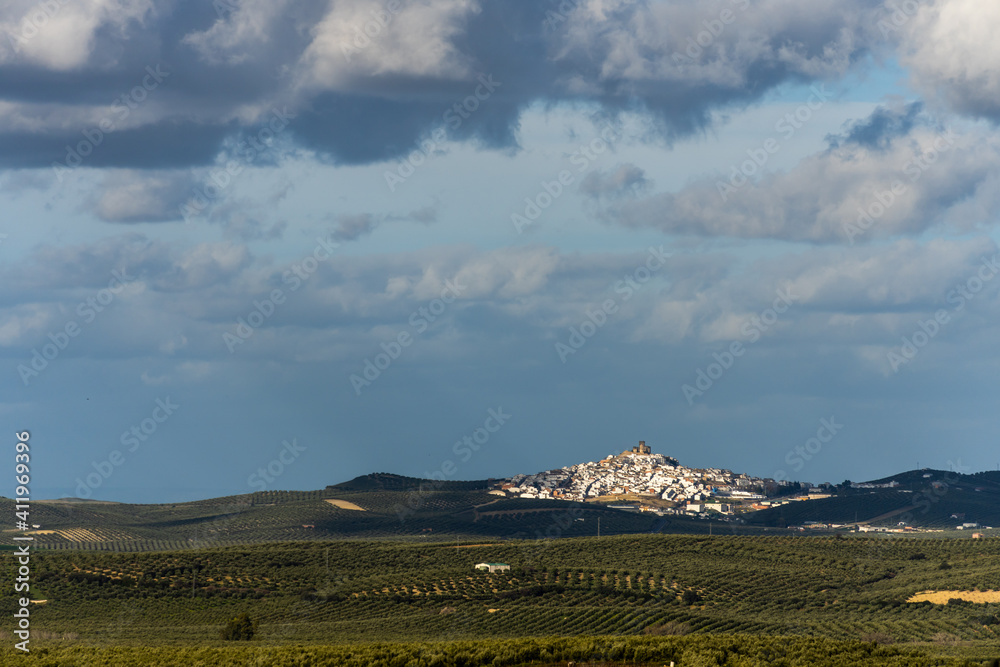 Stock photo of rural village of Espejo with white houses in the middle of olive trees plantation.