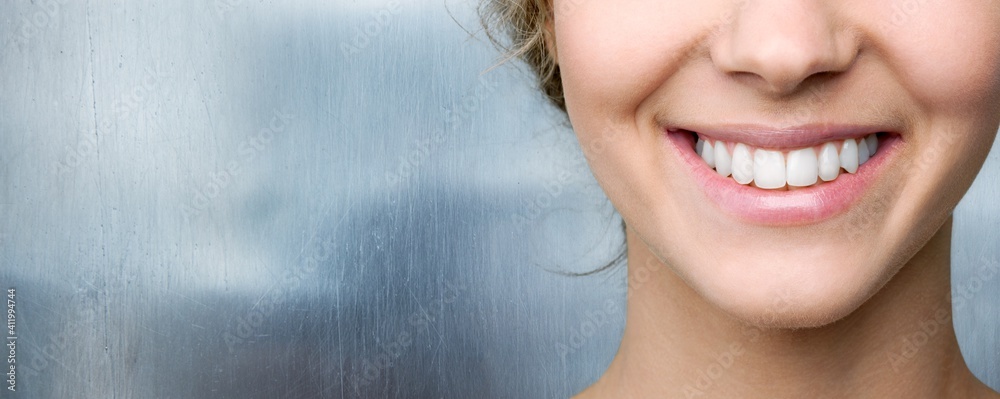 Beautiful smile of young woman with healthy white teeth