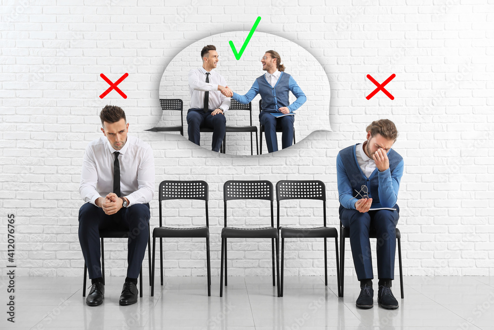 Young men waiting for job interview indoors