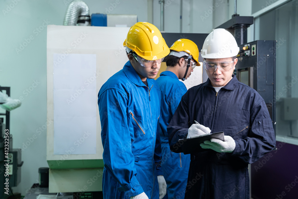 Asian team maintenance working in factory.