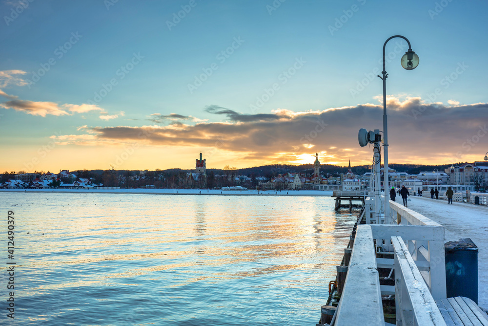 Beautiful sunset over the snowy pier (Molo) in Sopot at winter. Poland